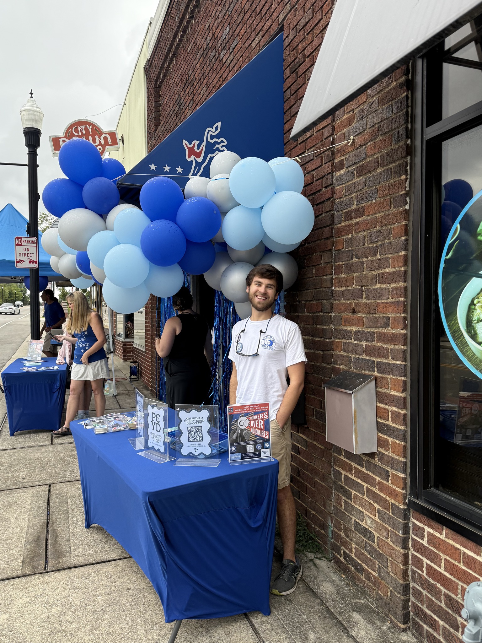 Brendan at College Town Kickoff 2025 with balloons and outreach table